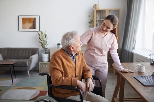 portrait-smiling-female-nurse-helping-senior-man-wheelchair-retirement-home-copy-space